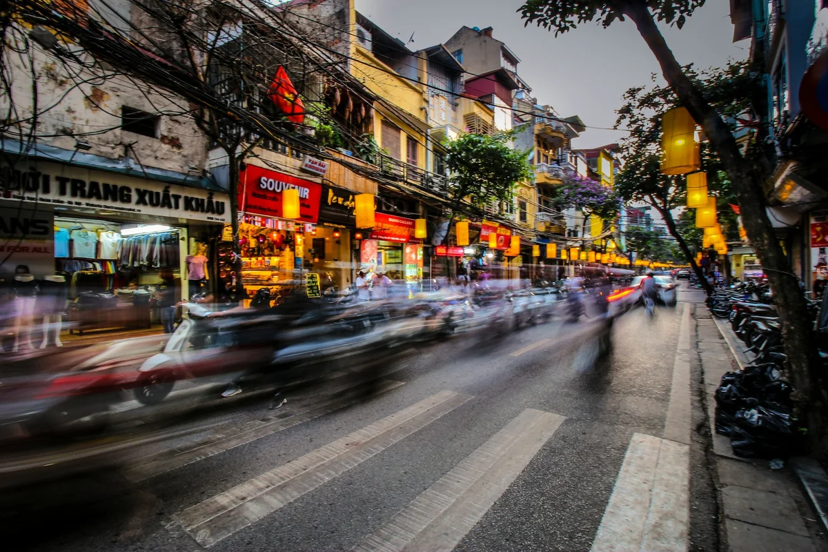 Busy streets of hanoi, lots of motorbikes and other traffic zooming past