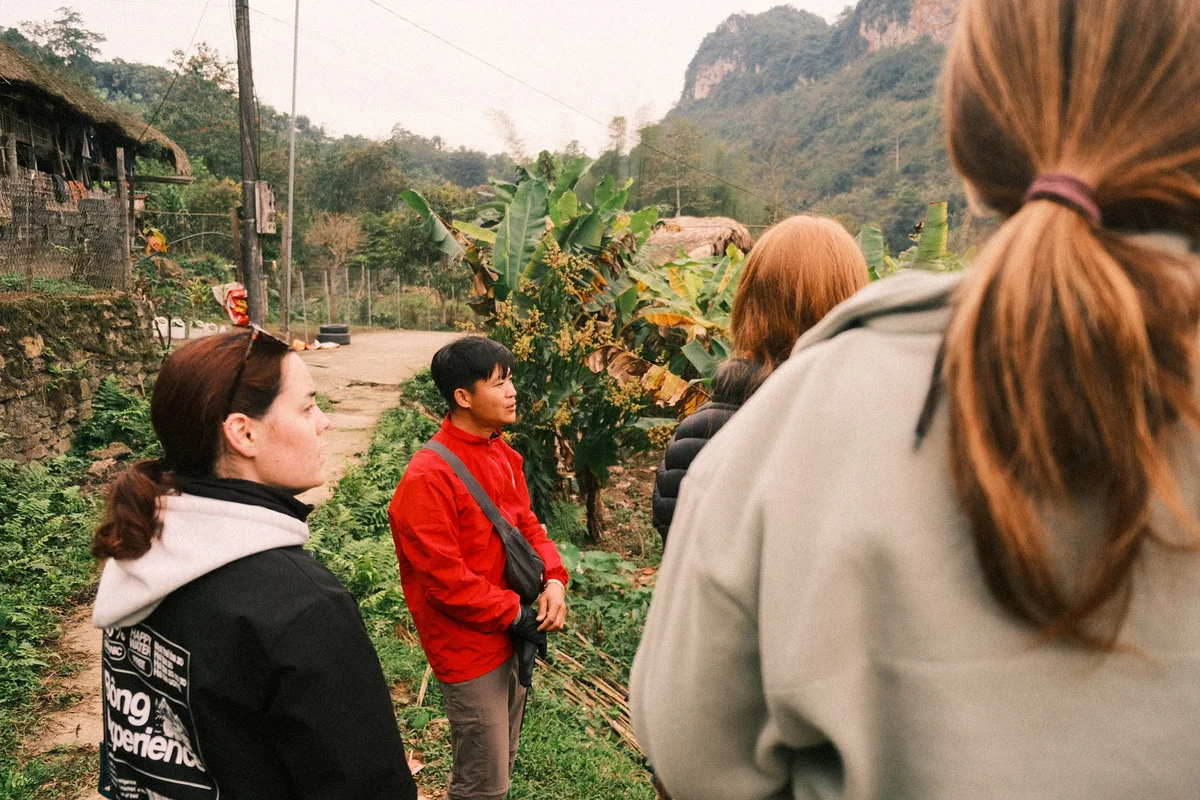 Bong Hostel tour guide explaining the detaisl of the secret village to some Bong Hostel guests