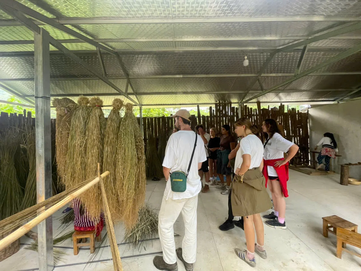 Guests watching a woman weaving on the Ha Giang Loop