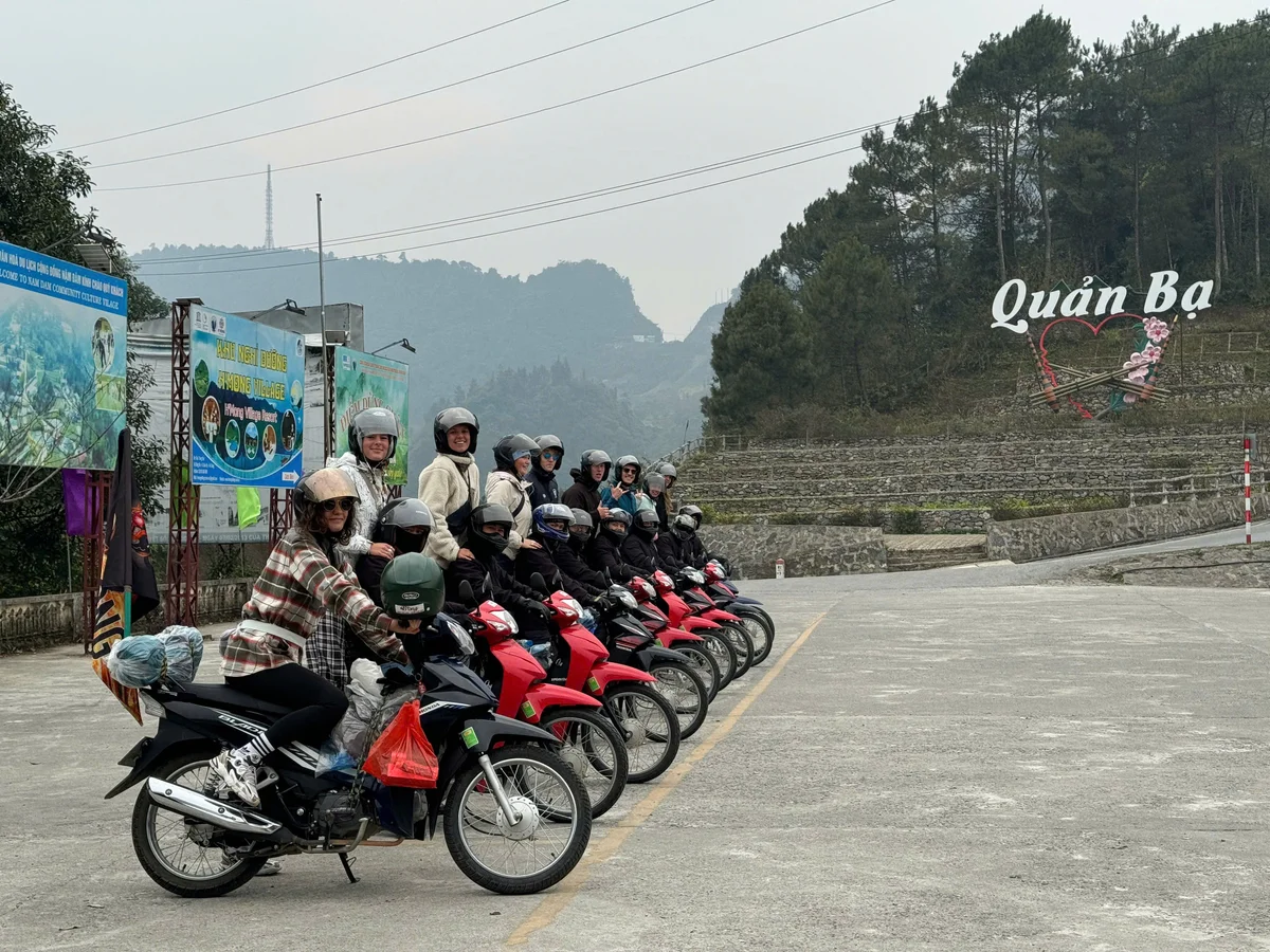 Group of self-riders lined up posing on their motorbikes