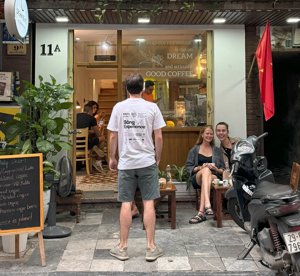 Bong hostel guest poses outside coffee shop in Hanoi