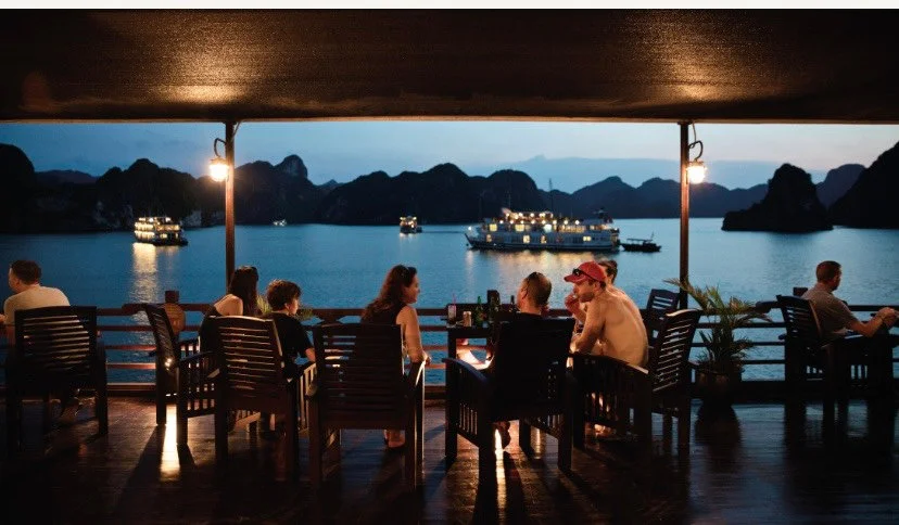 People sat around talking at night on a cruise ship