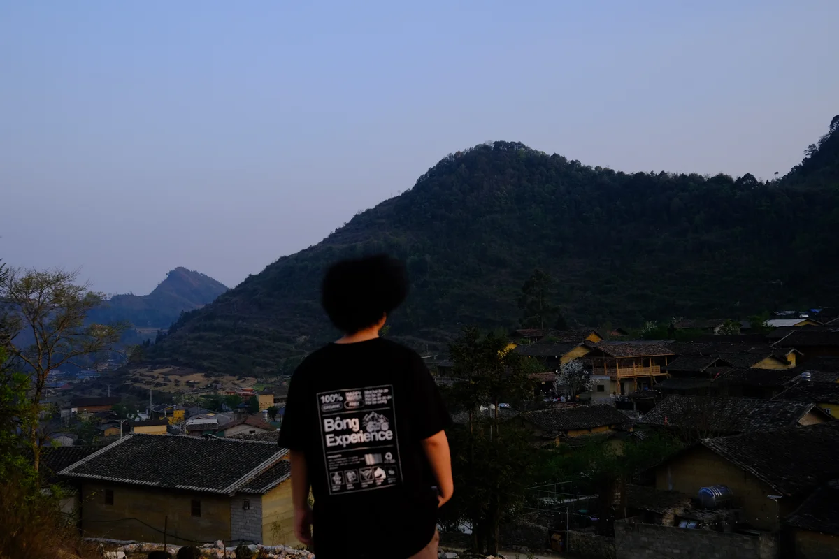 Girl overlooking a valley and local village on the Ha Giang Loop