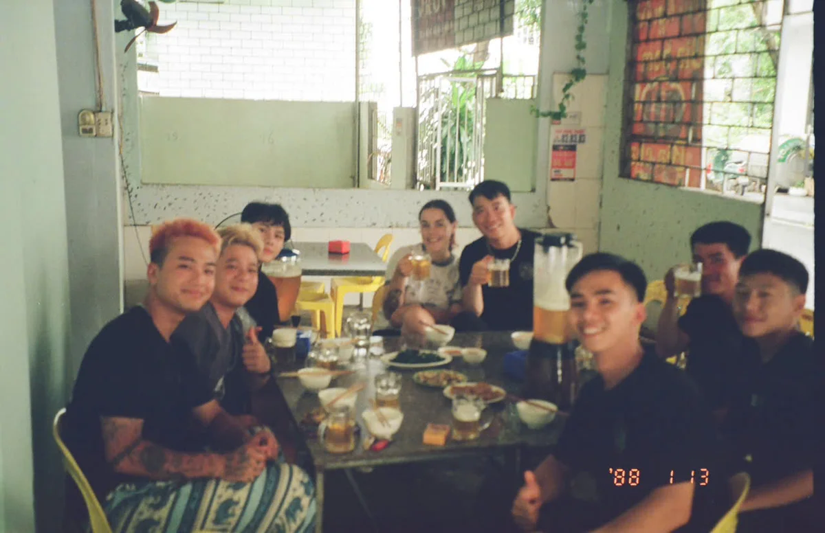 Group of easy riders having family-style dinner pose for a picture