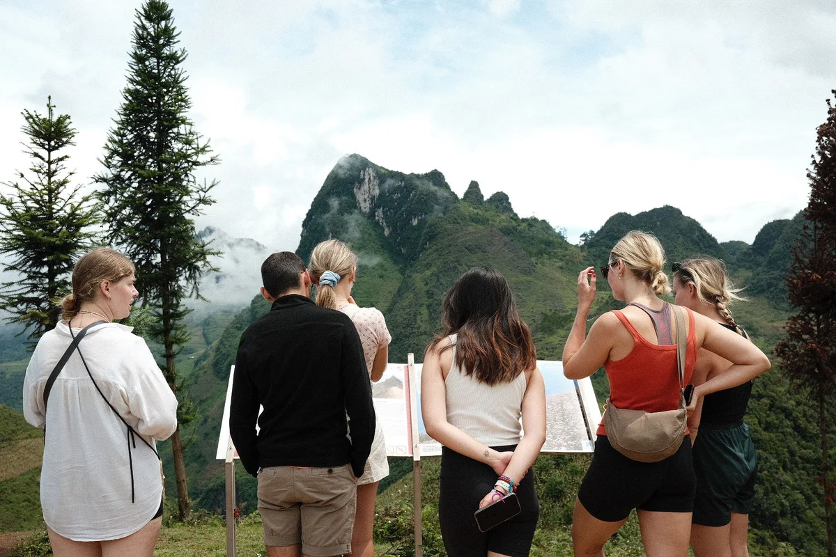 Guests looking at a sign on the Ha Giang Loop