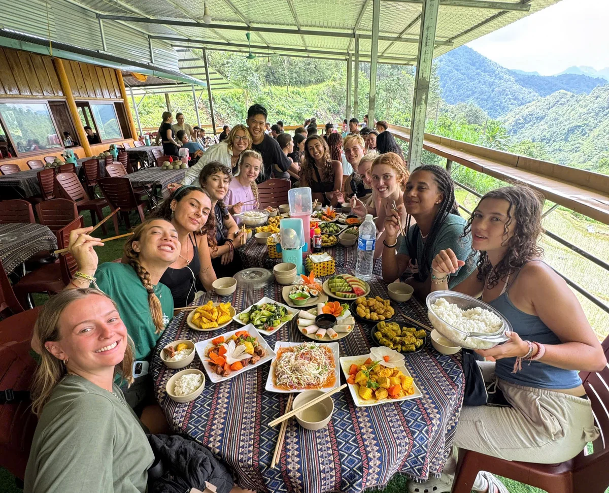 People sharing family dinner smile for the camera