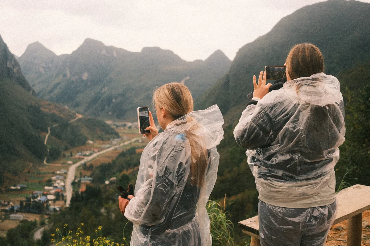 Two girls take pictures of the view on their phones
