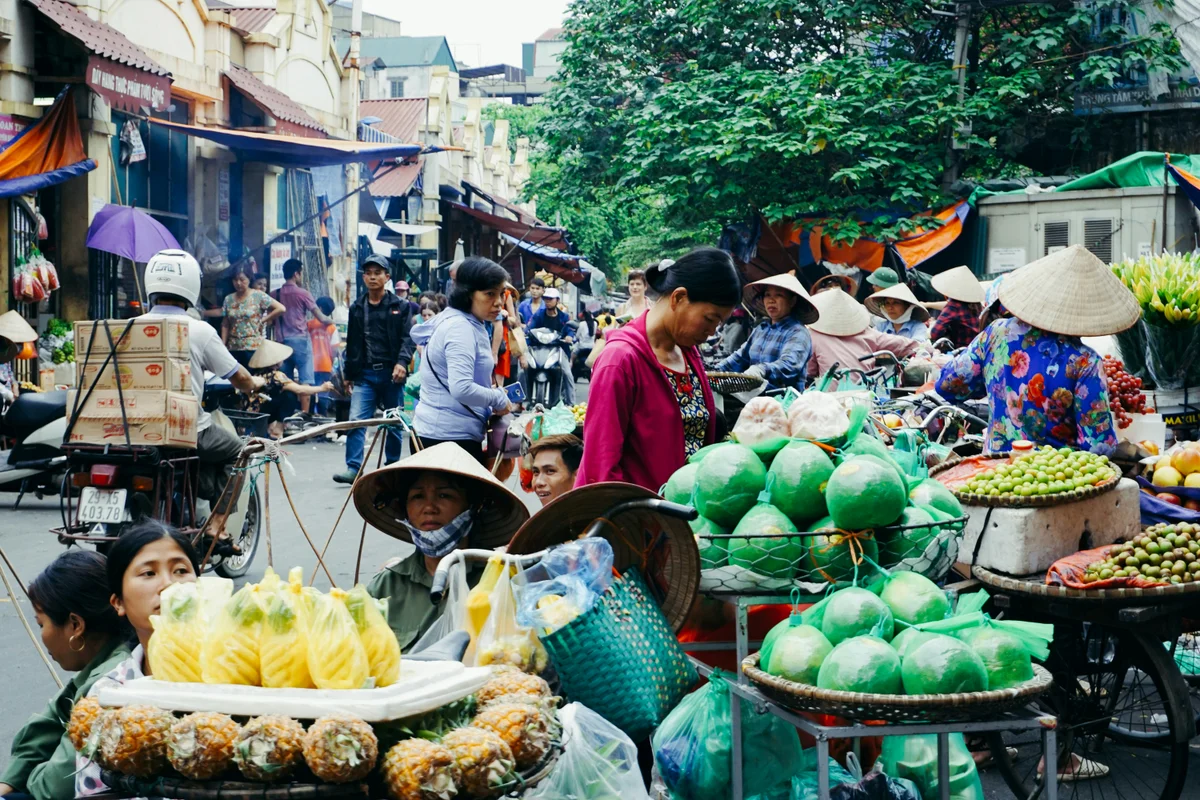 Fruit sellers working in a very busy street