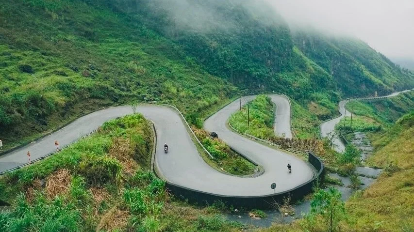 Winding road with mist and greenery